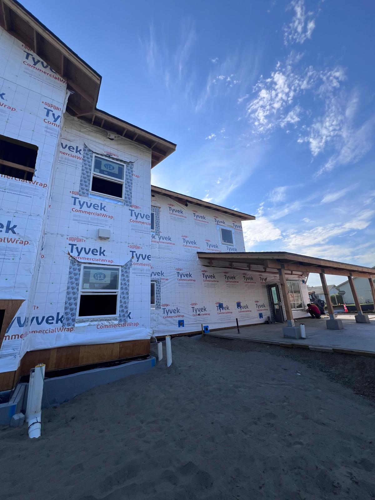Tyvek CommercialWrap WRB applied with VPI vinyl windows being installed on the front facade