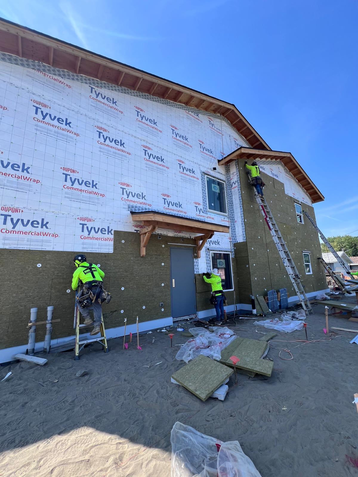 Full facade of Rockwool ComfortBoard rigid mineral wool insulation in progress