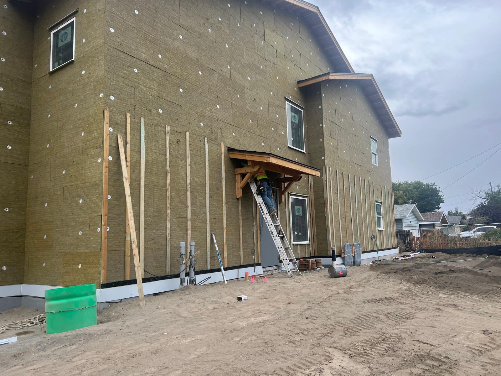 Rockwool insulation with vertical wood furring strips forming a ventilated rainscreen cavity