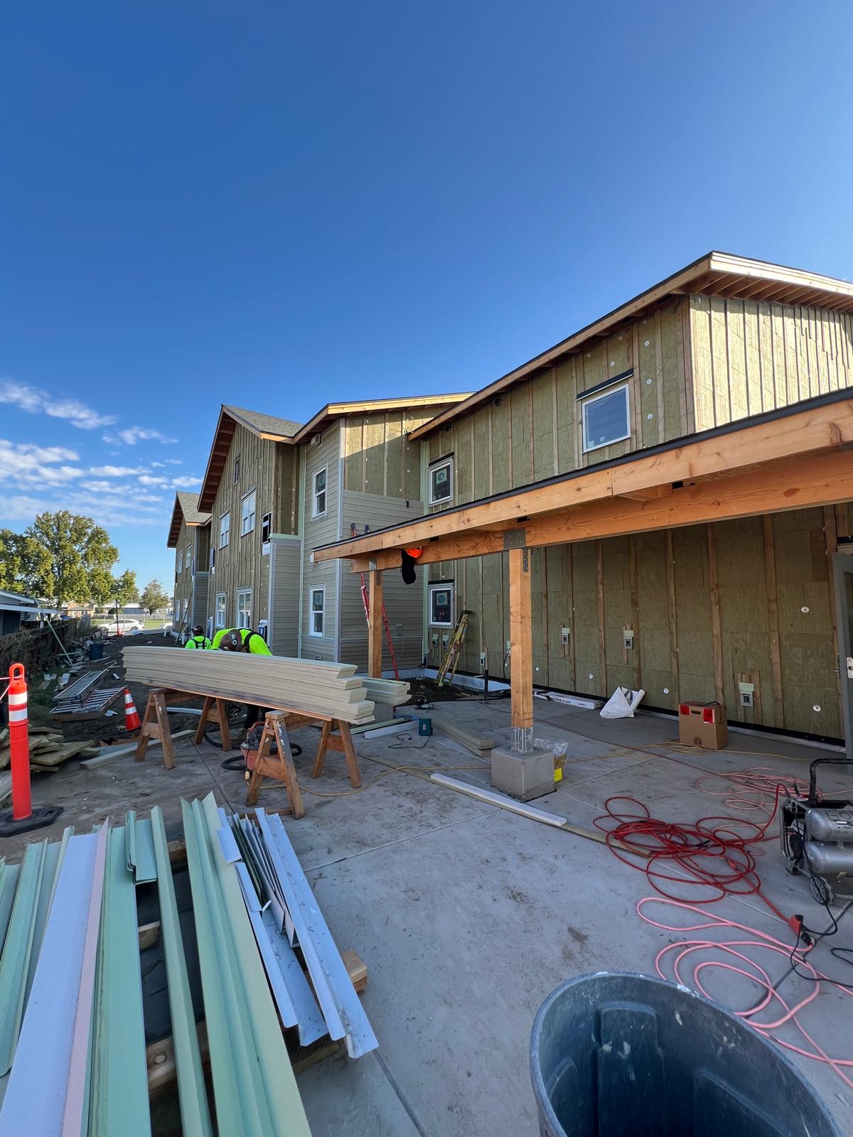 Corner elevation showing the transition from insulation to installed lap siding
